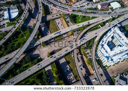 Aerial drone view looking straight down at Houston , Texas interstates and turn arounds , overpass , and interchange. Massive transportation highway traffic downtown Houston