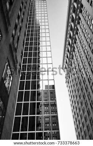 Modern architecture background. Urban background.Skyscrapers against sky in the city of Chicago, Illinois, USA. Black and white abstract upward view of downtown skyscrapers. 