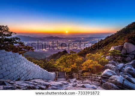 Sunrise at Baegundae peak and Bukhansan mountains in autumn,Seoul in South Korea. Royalty-Free Stock Photo #733391872