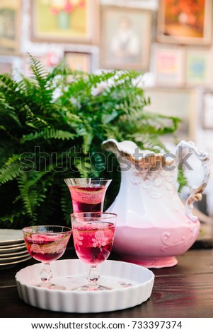 Colorful alcoholic cocktails in beautiful vintage glassware on a wooden table