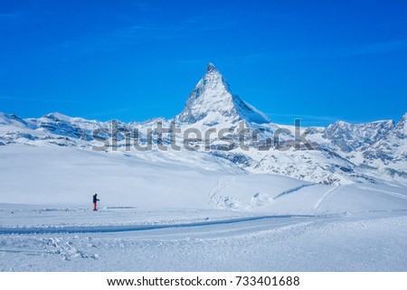 Skier see beautiful view of snow mountain Matterhorn peak, Zermatt, Switzerland.