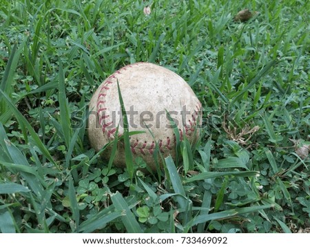 a baseball on green grass