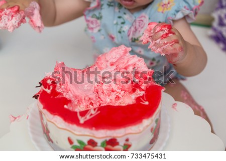 Children's hands in a cake