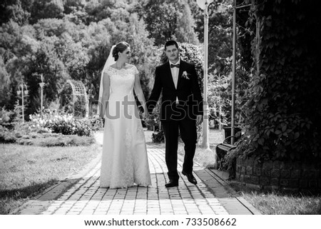 Wedding beautiful couple with good mood kisses on a nature. Love is all you need. Plus size tenderness bride and younger groom