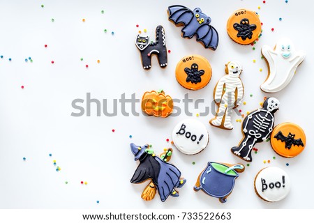 Bright halloween gingerbread cookies on white background top view.
