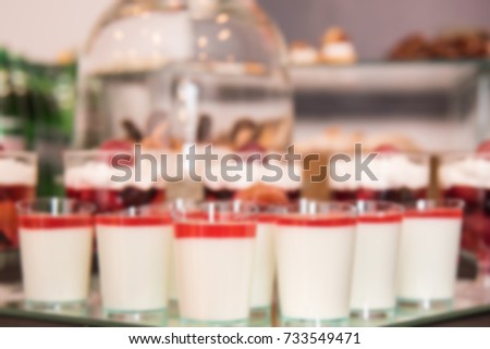 Desserts with fruits, mousse, biscuits. A grouping of desserts from strawberry cheesecake to powdered donuts. Festive culinary sweet masterpieces. Blurred abstract picture. Delicious Desserts. 