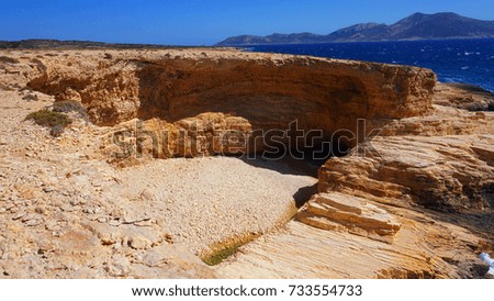 Photo of famous rocky seascape of Koufonisi island with caves and turquoise - sapphire clear waters, Cyclades, Greece                         
