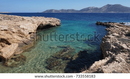 Photo of famous rocky seascape of Koufonisi island with caves and turquoise - sapphire clear waters, Cyclades, Greece                 