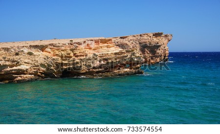 Photo of famous rocky seascape of Koufonisi island with caves and turquoise - sapphire clear waters, Cyclades, Greece                      