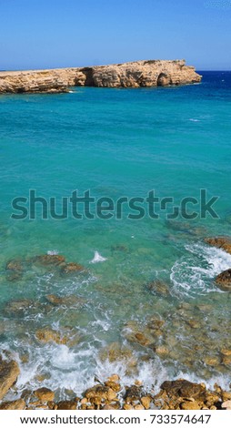 Photo of famous rocky seascape of Koufonisi island with caves and turquoise - sapphire clear waters, Cyclades, Greece                      