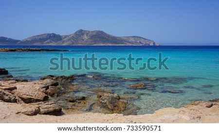 Photo of famous rocky seascape of Koufonisi island with caves and turquoise - sapphire clear waters, Cyclades, Greece         