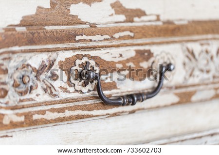 Old wooden antique chest of drawers with metal handles closeup. Royalty-Free Stock Photo #733602703