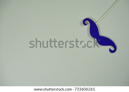Top or flat lay view of birthday props, purple mustache on isolated white background. Birthday parties text and props.