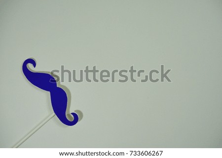 Top or flat lay view of birthday props, purple mustache on isolated white background. Birthday parties text and props.