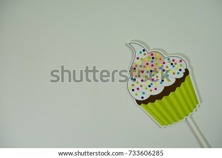 Top or flat lay view of birthday props, cupcake on isolated white background. Birthday parties text and props.