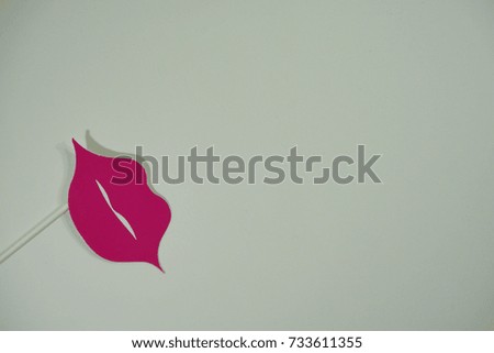 Top or flat lay view of birthday props, pink lips on isolated white background. Birthday parties text and props.