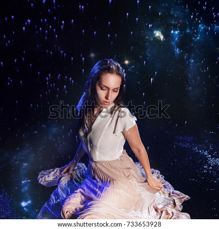 Photo art, young woman dreams to starry sky. Elements of this image furnished by NASA.