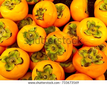 Many Fresh Persimmons Different Sizes Background  Royalty-Free Stock Photo #733673569