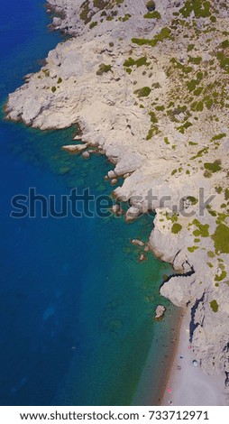 Summer 2017: Aerial birds eye view photo taken by drone of rocky tropical beach with turquoise clear waters