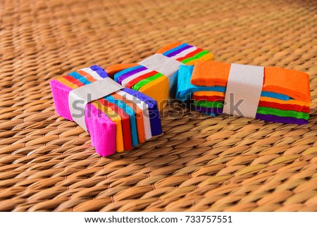A rainbow wrapper rests on a reed mat.
