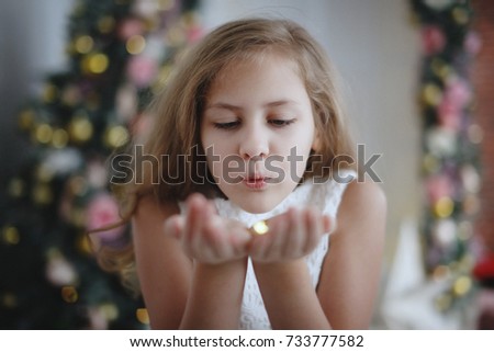 Christmas teen girl blowing snow