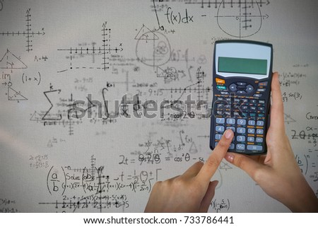 Hands of businesswoman using calculator against quadratic equations with solution