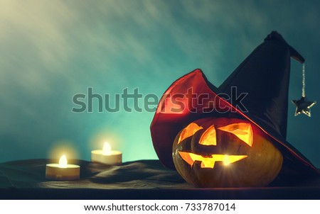 halloween pumpkin head with witch hat and candle light in darkness spooky background, halloween background