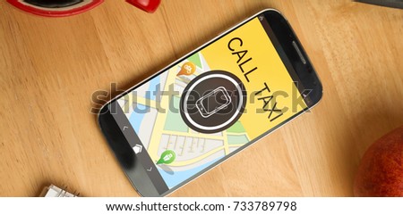 Digitally generated image of mobile phone with text and map against smartphone on desk