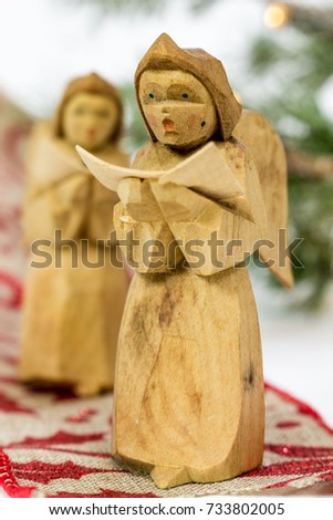 Close-up of a small hand carved wooden angel.