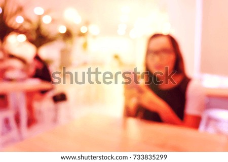 Blurred image of The people sitting and working in coffee shop.