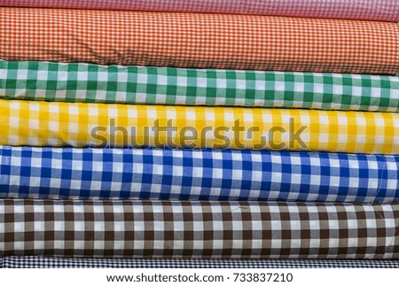 Colorful fabric scarves in stack as background 