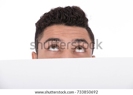 Cropped photo of man's head with eyes looking to up, behind a white banner. Isolated on white background.