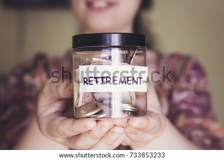woman with beautiful smile hold a retirement plastic jar for save money