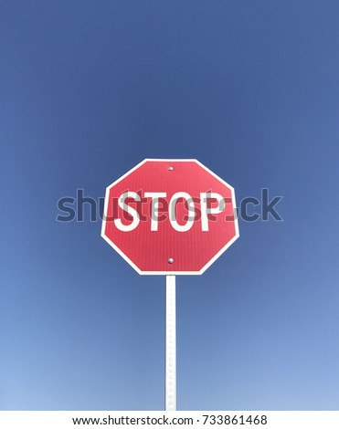 Stop Sign against a cloudless blue sky