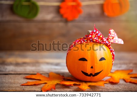 Cute smiling pumpkin wearing red bandana. Close-up