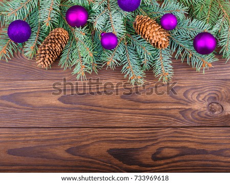 Winter concept of fir-tree on a brown wooden background
