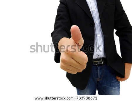 Man in black suit and jean pant is standing and gesturing thumb up by right hand to appreciate other one.