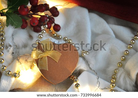 Golden heart present box on christmas decoration background with copy space