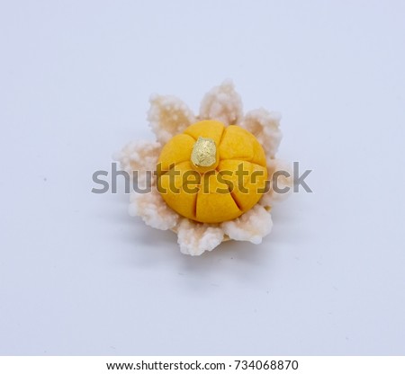 Traditional Thai sweet dessert mainly made by egg yolks , sugar on top with gold leaf .this picture on white background