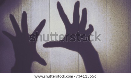 Silhouette of hand women on the wall to show ghost and horribleness halloween concept