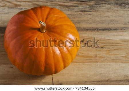 background with big yellow pumpkin on wooden board