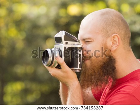 Photographer with a beard, film camera, medium format