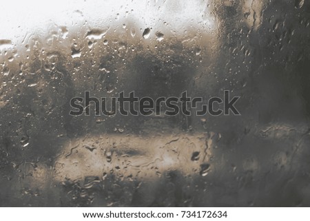 Water drops of rain on glass background after rain. Toned