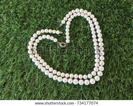 Pearl necklace on grass