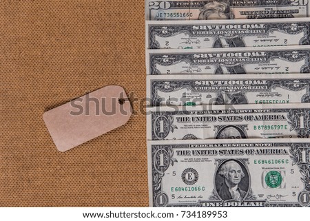 a tag with copyspace for black Friday on the background of a cardboard texture and American dollars
