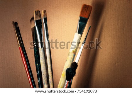 Artistic brushes on the background of corrugated cardboard. The artist's tools.