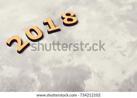 2018 over the grey concrete background.