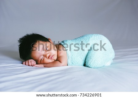 Asian Baby Peaceful Sleeping On White Bed