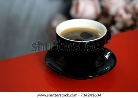 Well mixed black coffee in black coffee cup on a table in a restaurant, aroma drink refreshment in comfort environment for better meeting with business partner, friends or lovers