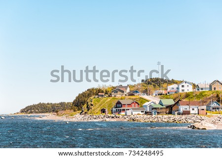 Cityscape of Grosses-Roches village town and Saint-Lawrence river during day with colorful houses